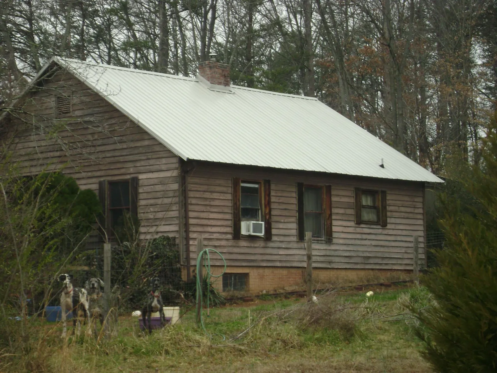 White metal roof on an old wood sided farmhouse, from a Metal Roof Installation job in Becket